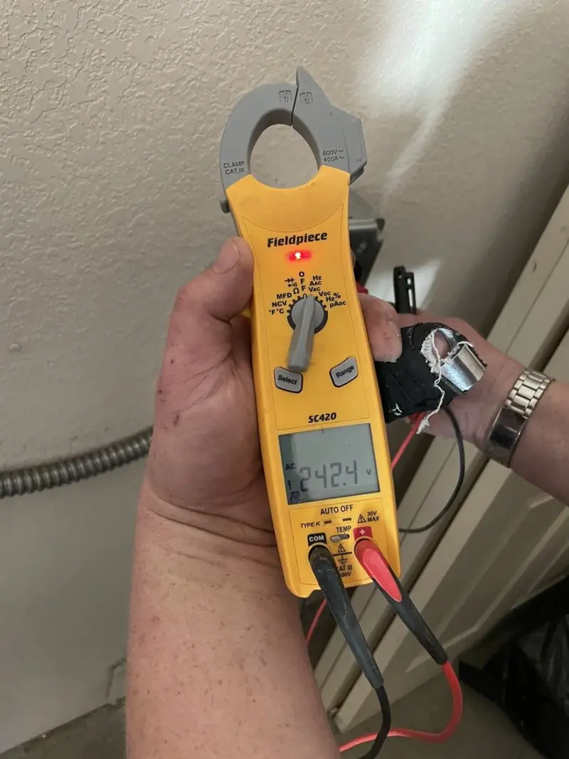 Voltage testing with clamp meter during Outlet Installation in Crystal Lake